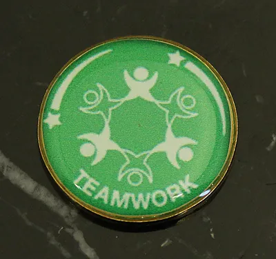 Green Teamwork round pin badge with linked figures